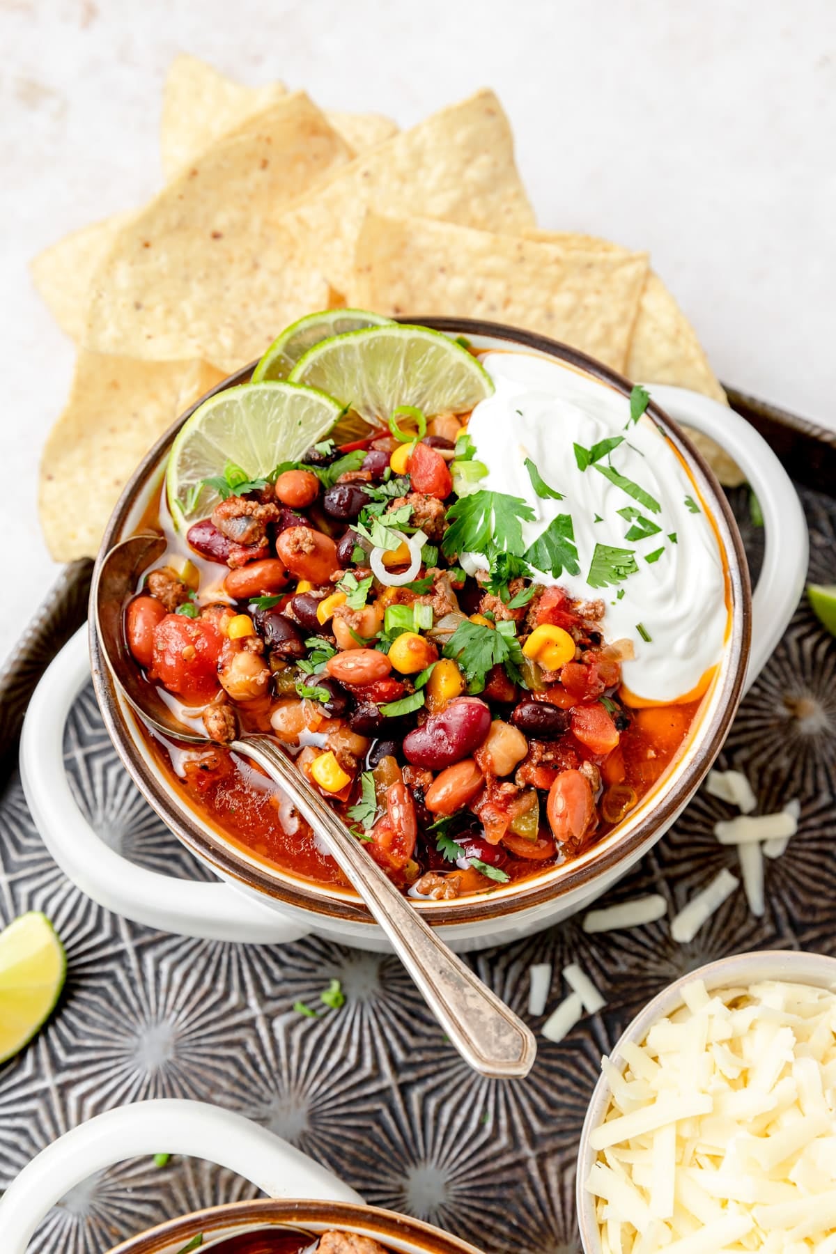bowl of crock pot beef chili with lime slices.