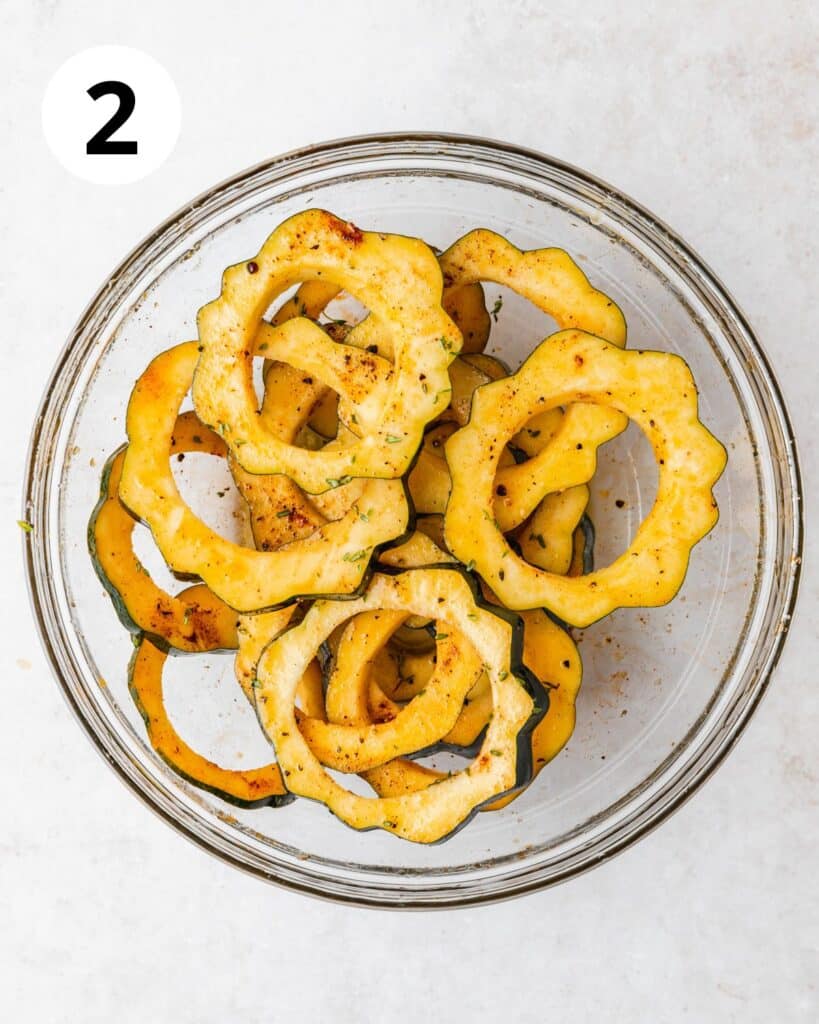 tossing squash in olive oil and spices.