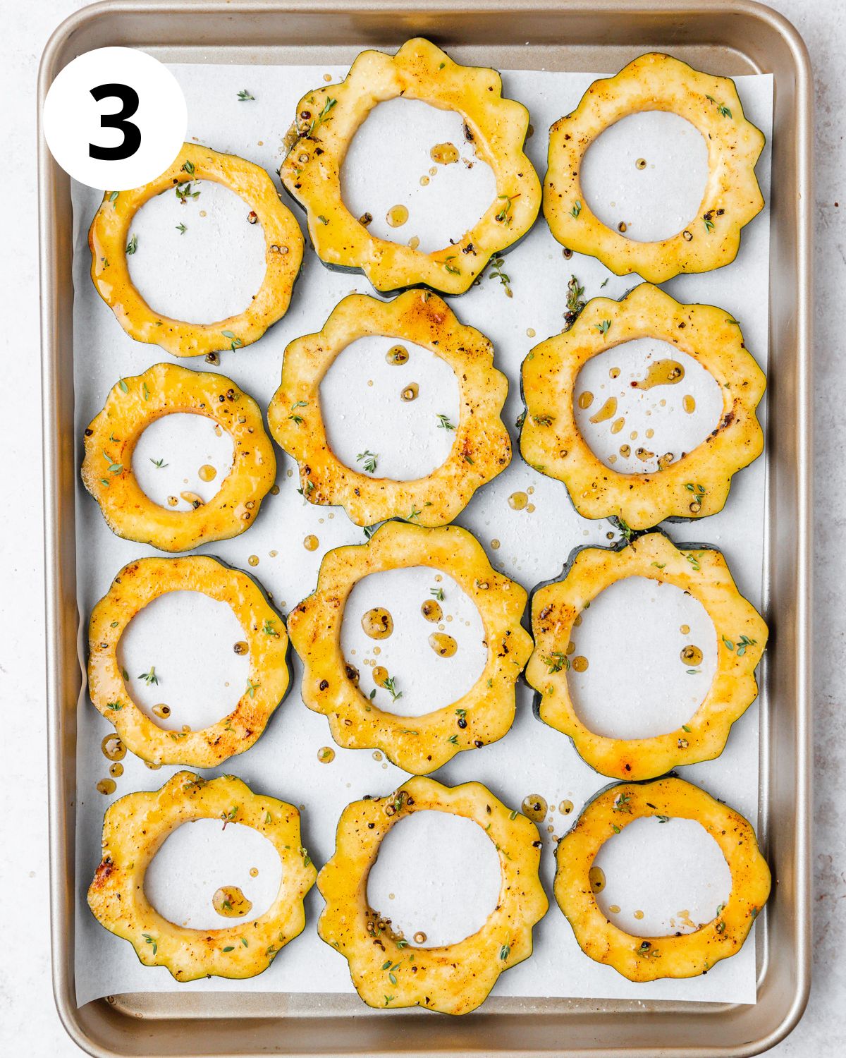 acorn squash on pan before roasting.