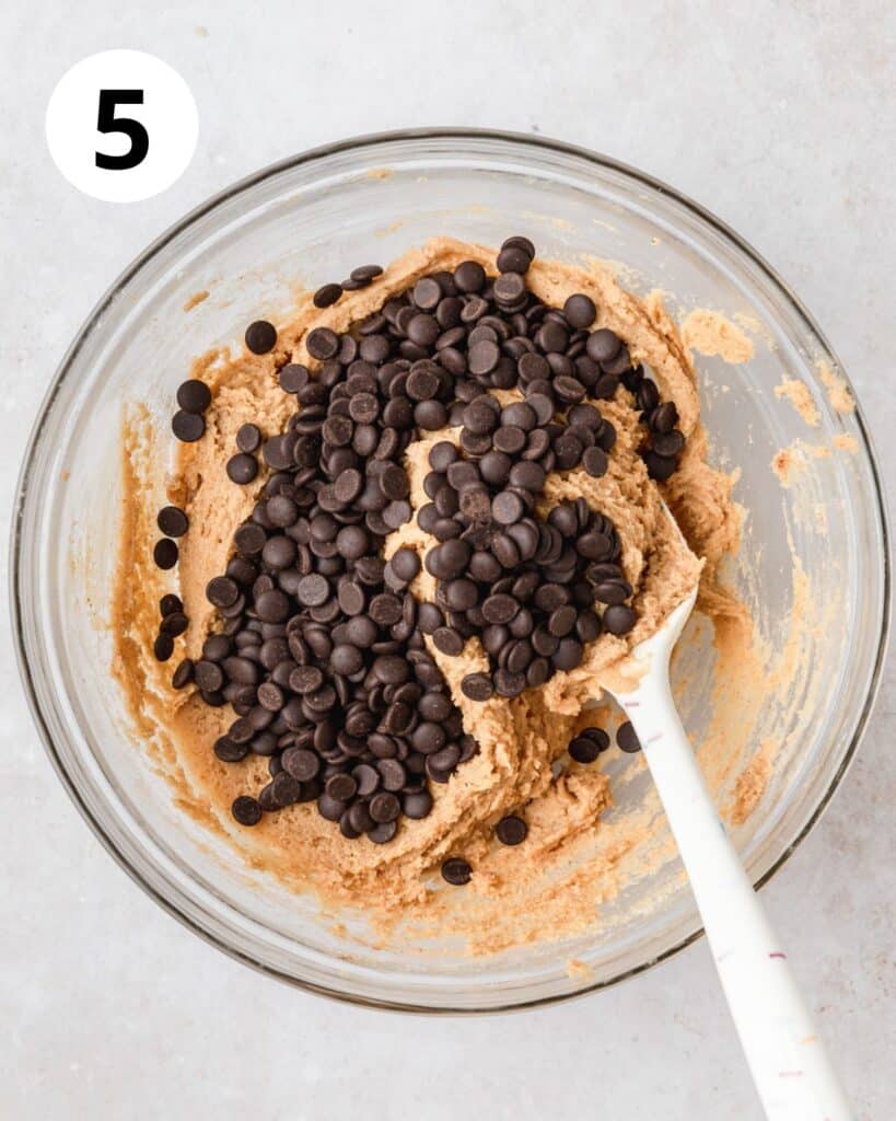 adding chocolate chips to pumpkin blondie batter.
