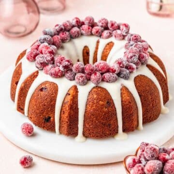 close up of cranberry bundt cake with sugared cranberries.