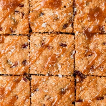 close up of pumpkin caramel blondies with pecans and flaky sea salt.