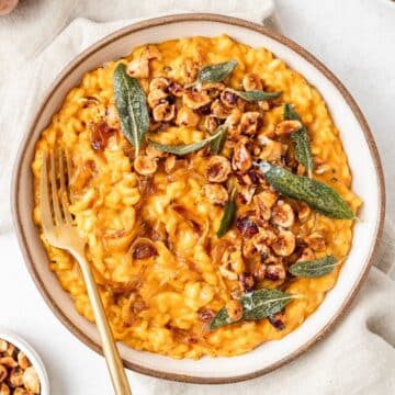 close up of pumpkin risotto with toasted hazelnuts.
