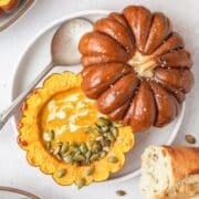 close up of spicy curried pumpkin soup in pumpkin bowls.