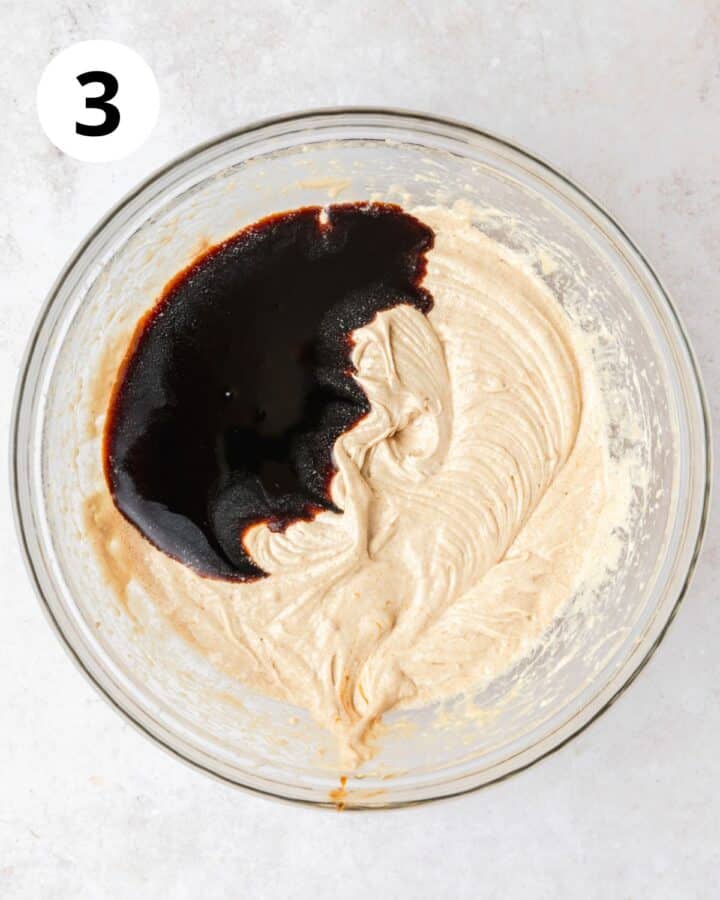adding molasses to cake batter.