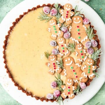close up of eggnog custard tart topped with gingerbread cookies.