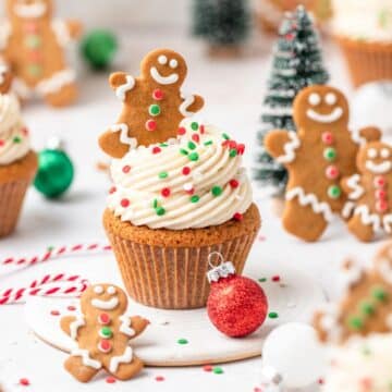 close up of gingerbread cupcakes topped with mini gingerbread men.