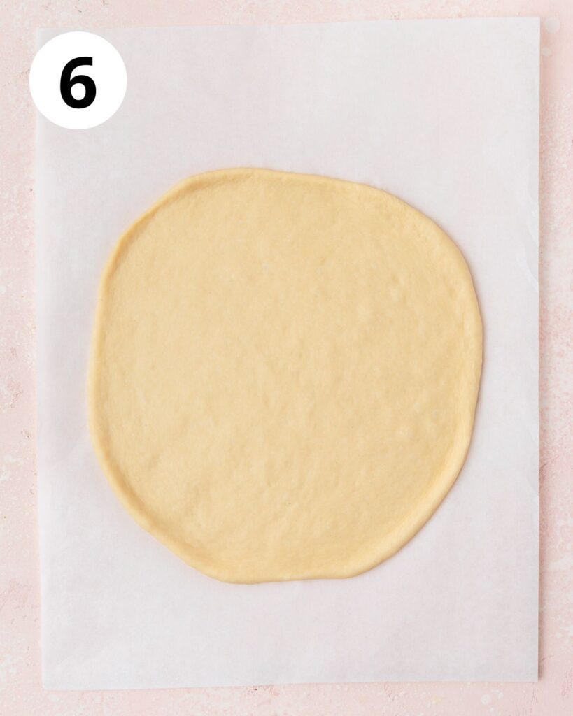 rolling dough into large circle.