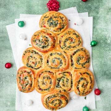 close up of christmas tree shaped spinach artichoke rolls.