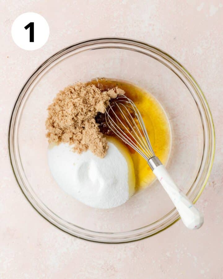 whisking oil and sugars together.