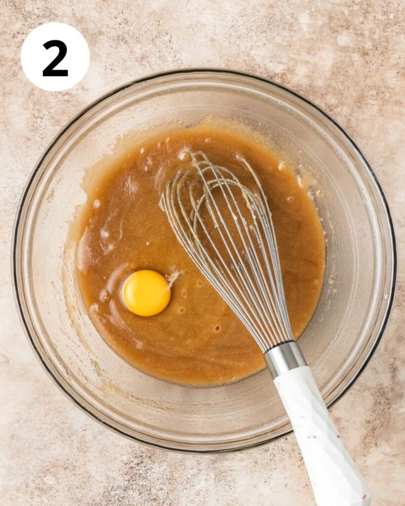 adding in first egg to brownie batter.