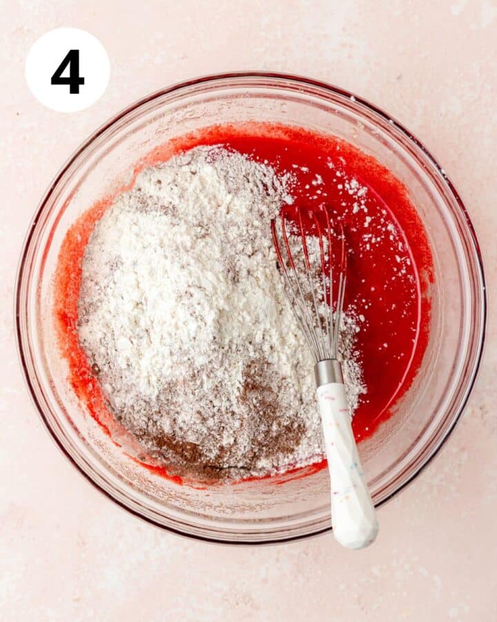 adding dry ingredients to cake batter.