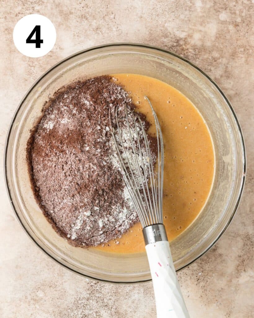 adding dry ingredients to brownie batter.