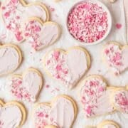 close up of frosted sugar cookies shaped like hearts.