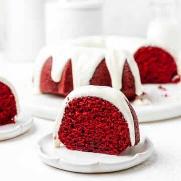 close up of red velvet bundt cake with cream cheese glaze.