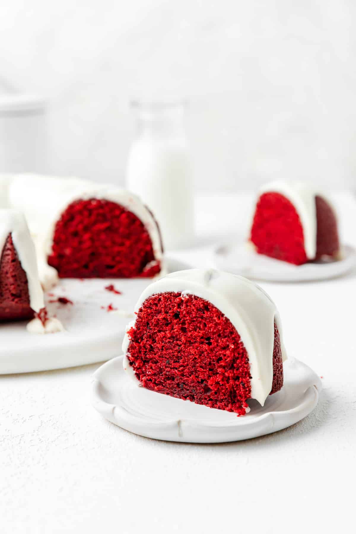 slice of red velvet bundt cake with cream cheese glaze.
