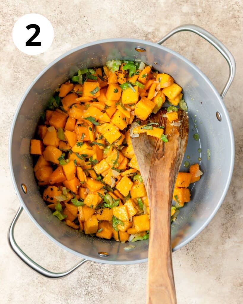 adding butternut squash and herbs to soup.