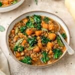 close up of butternut squash soup with barley and kale..