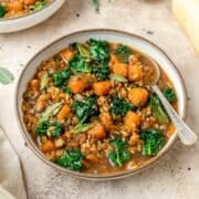 close up of butternut squash soup with barley and kale..