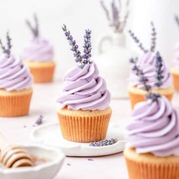 close up of honey lavender cupcakes with lavender flowers.
