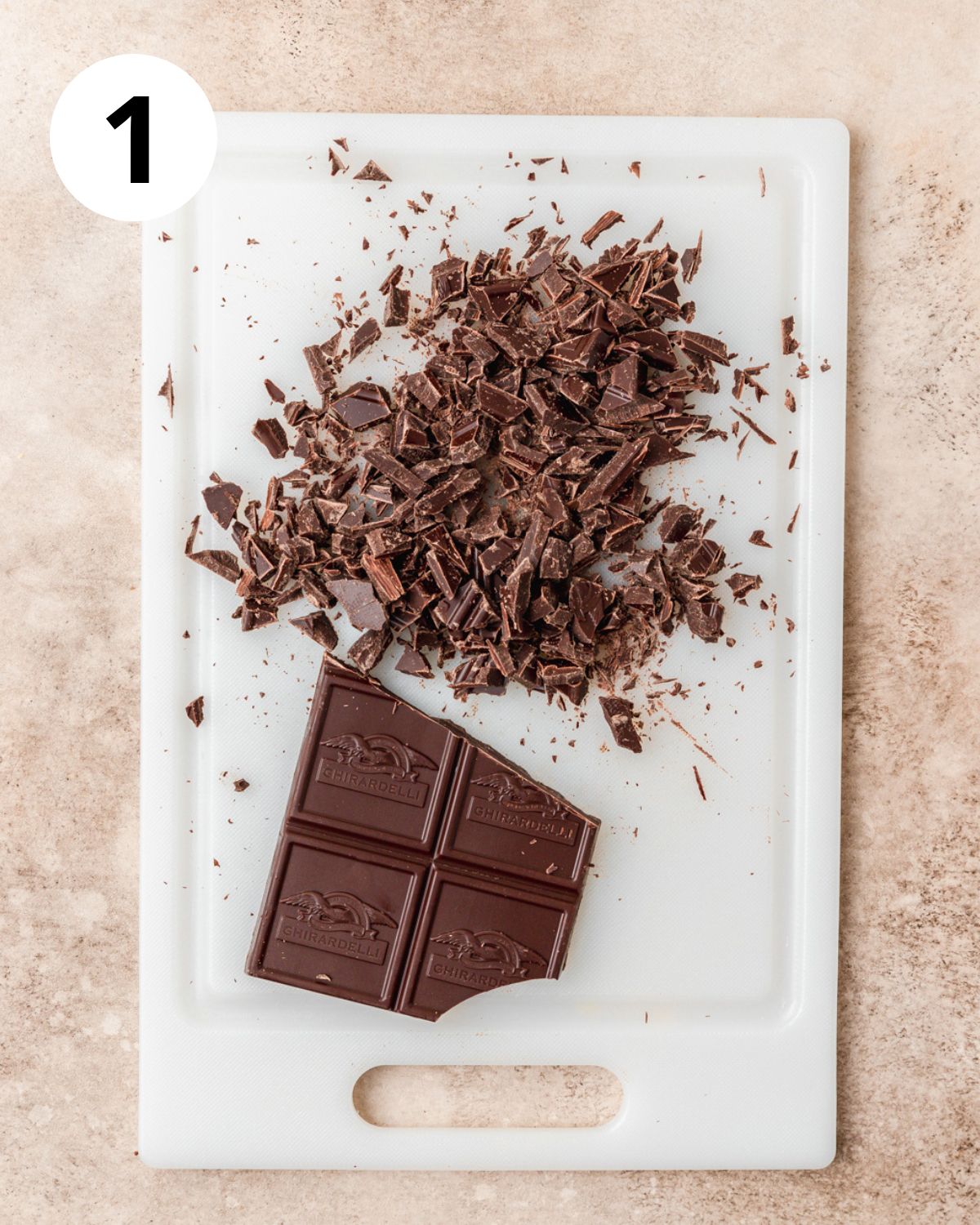 roughly chopping dark chocolate.
