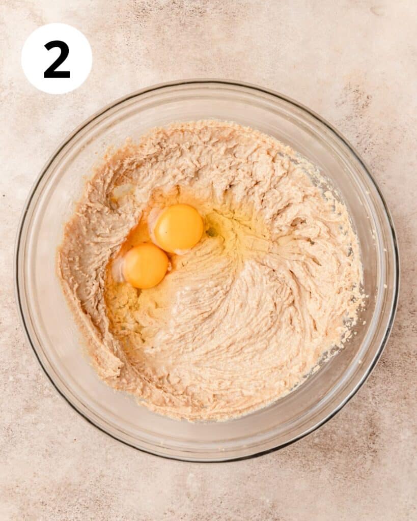 adding eggs to blondie dough.