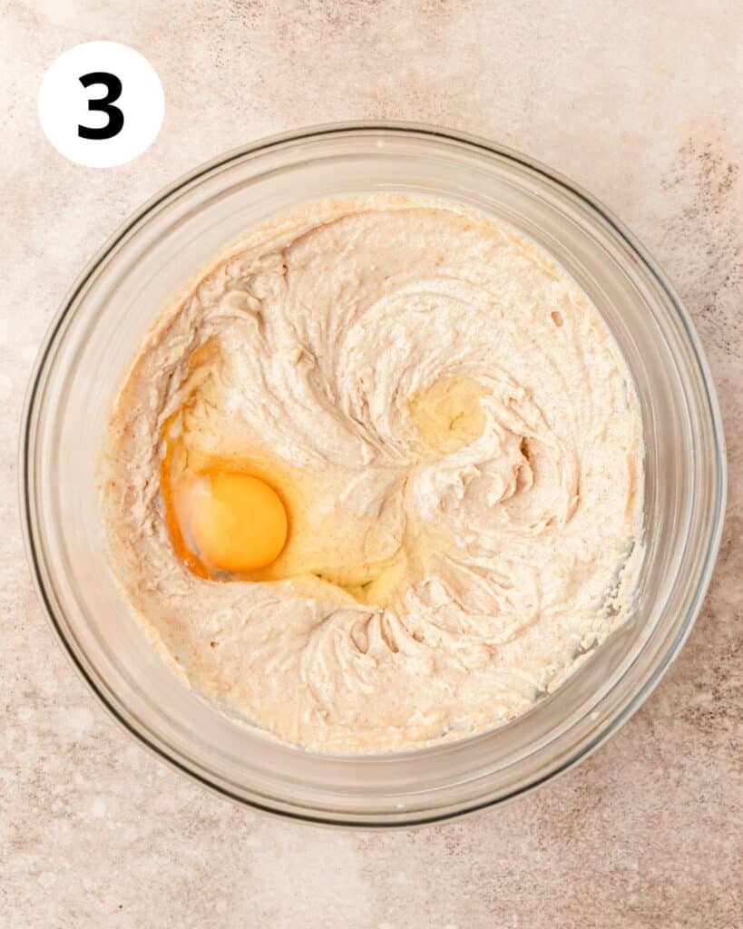 adding egg to cookie dough.