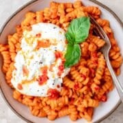 close up of calabrian chili pasta with burrata.
