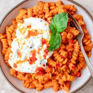close up of calabrian chili pasta with burrata.