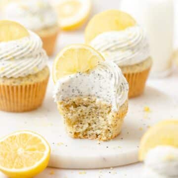 close up of lemon poppy seed cupcakes with cream cheese frosting.