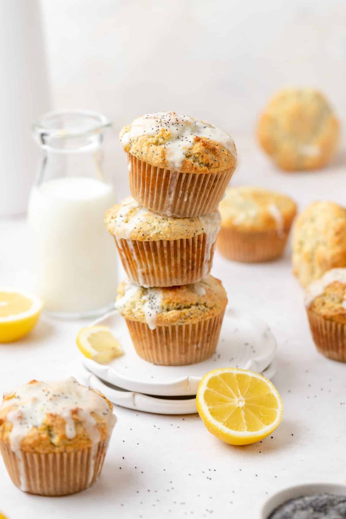 stack of lemon poppy seed muffins with lemon glaze.