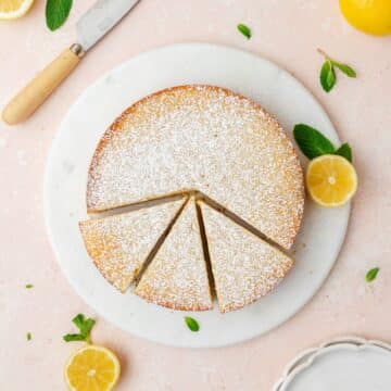 close up of lemon ricotta cake topped with powdered sugar.