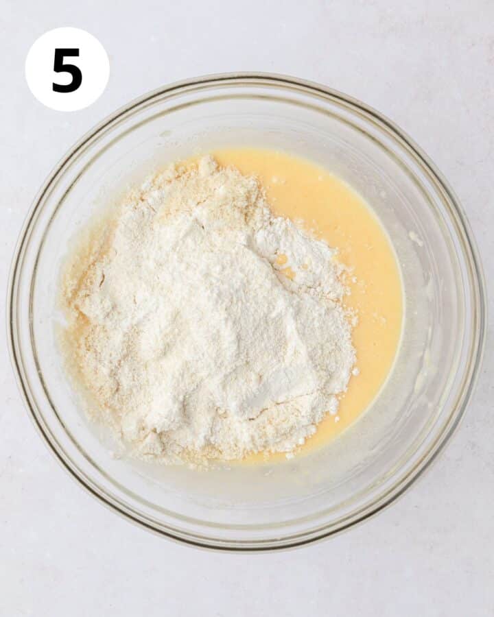 adding dry ingredients to muffin batter.