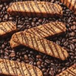 close up of espresso biscotti drizzled with dark chocolate.