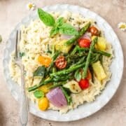 close up of creamy orzo with roasted summer vegetables.