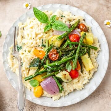 close up of creamy orzo with roasted summer vegetables.