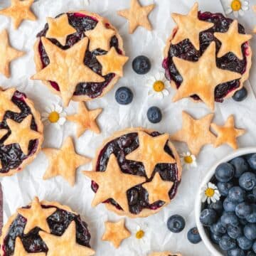 close up of mini blueberry pies with star pie crust cutouts.