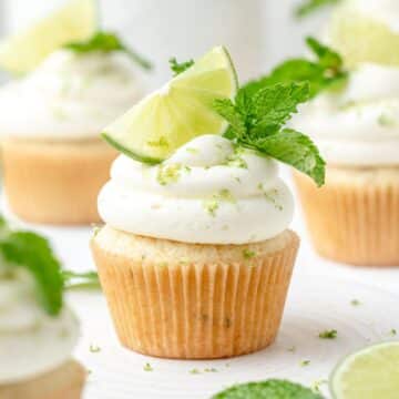 close up of mint mojito cupcakes with cream cheese frosting.