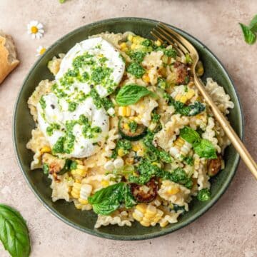 close up of summer pasta with corn, zucchini, and burrata.