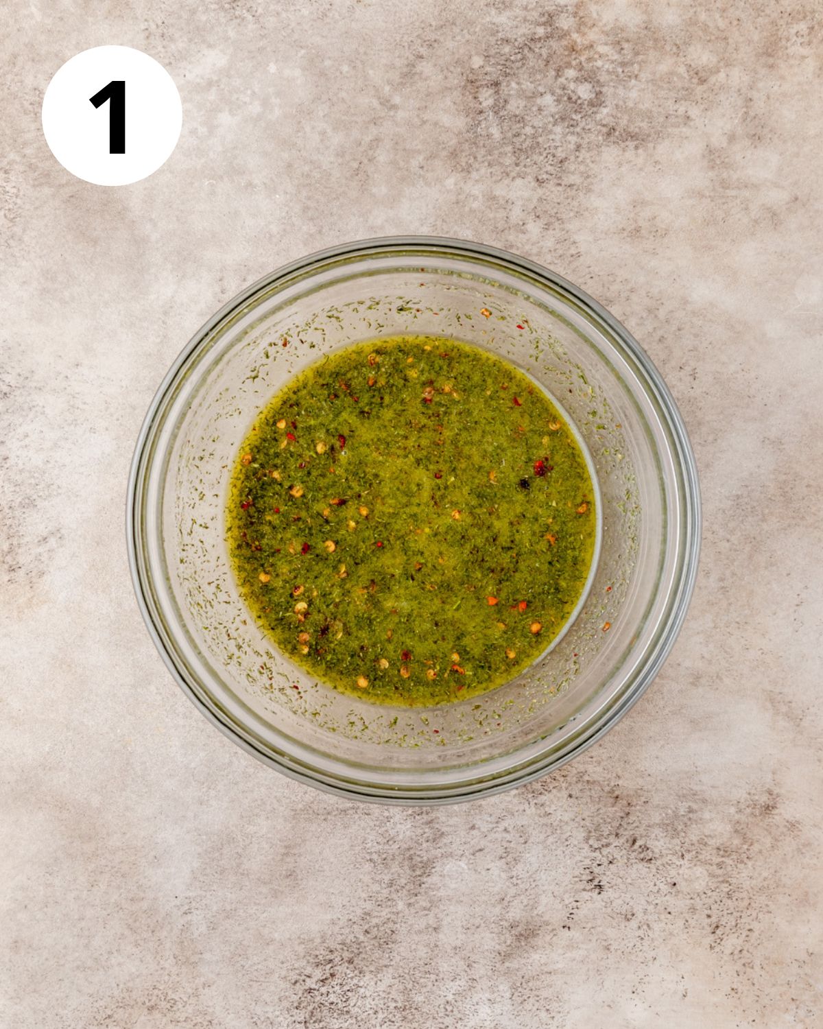 mixing oil and seasonings in bowl.