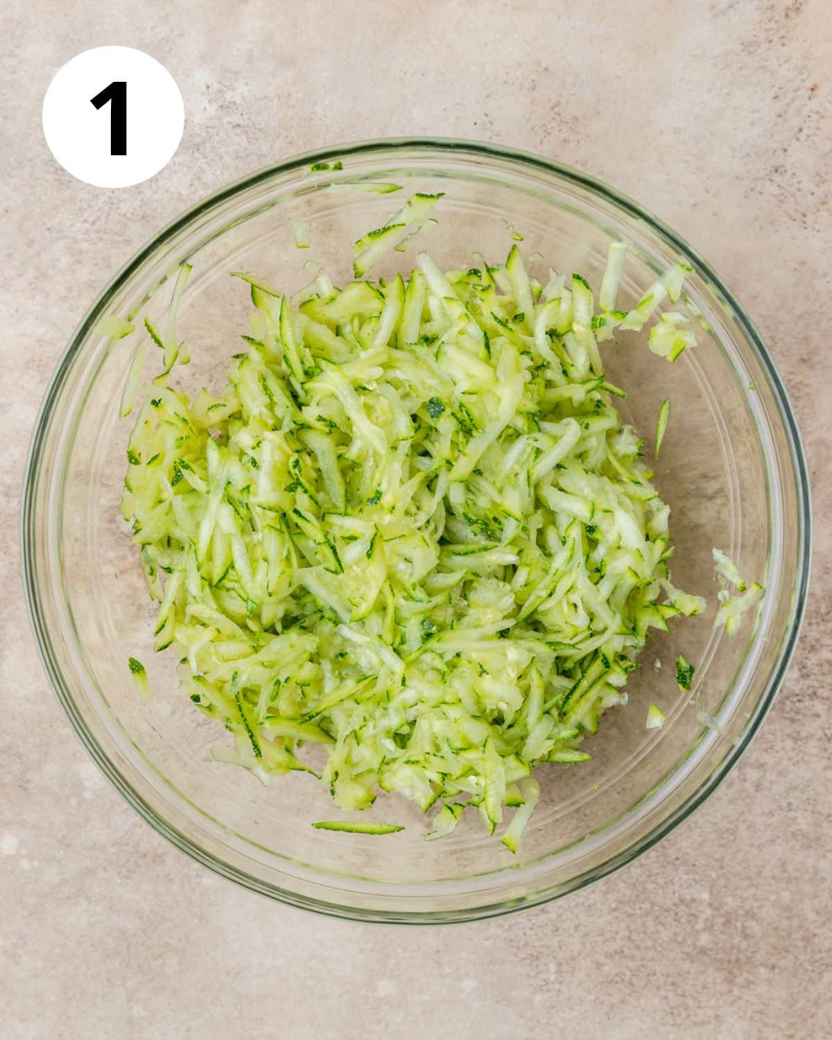 grated zucchini in bowl.