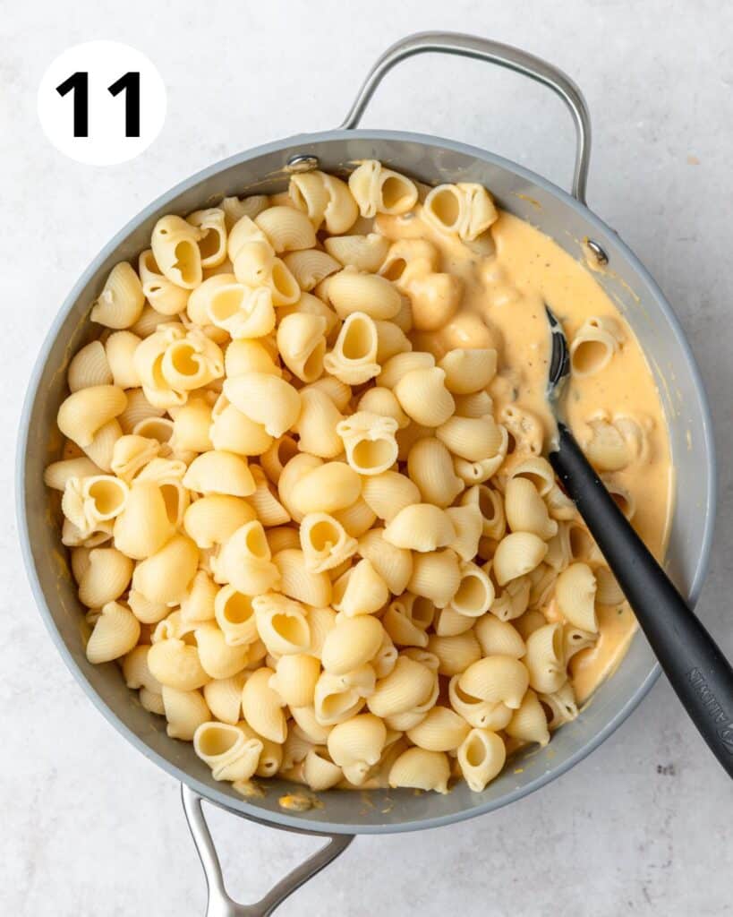 adding cooked pasta to cheese sauce.