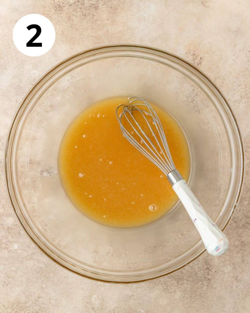 whisking honey and melted butter.