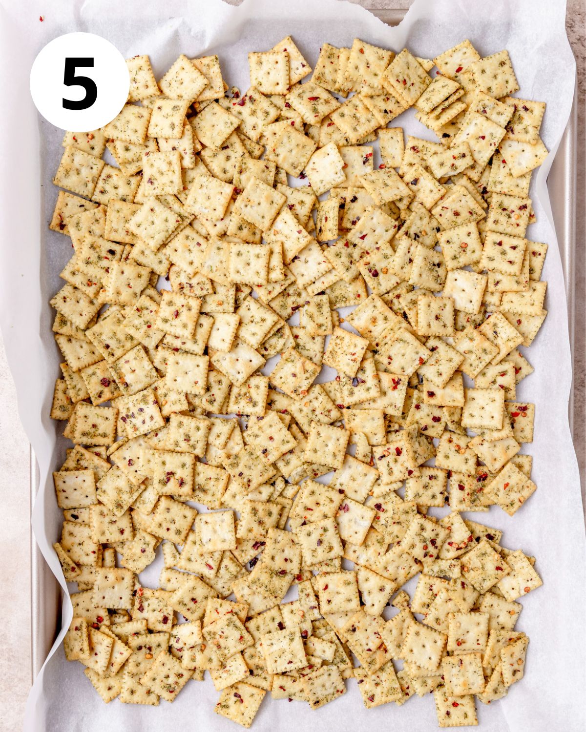 toasting seasoned crackers on baking sheet.