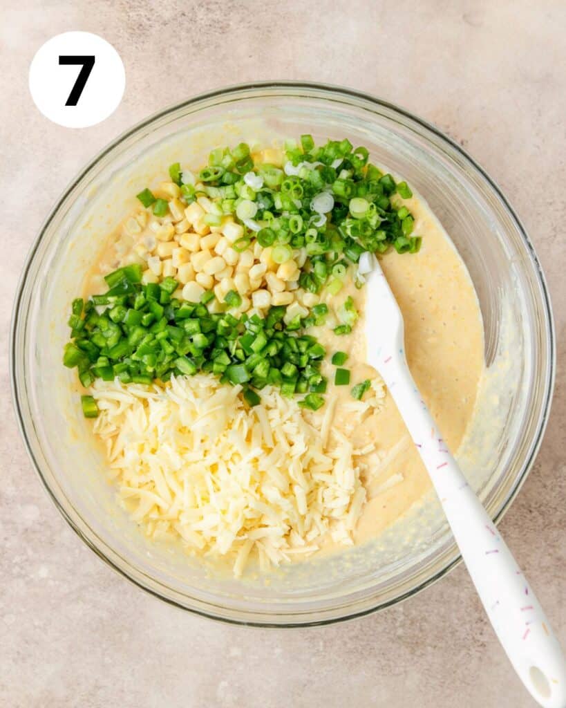adding cheese, jalapenos, green onions, and corn to cornbread batter.