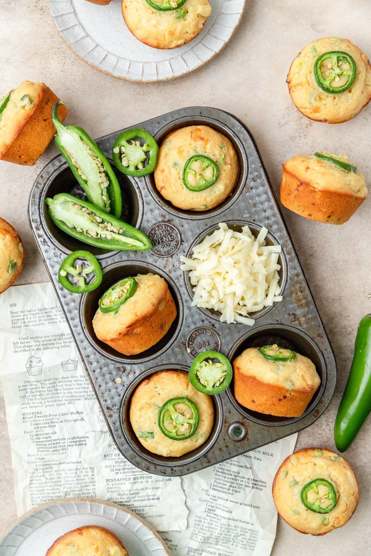 jalapeno cheddar cornbread muffins topped with sliced jalapenos.