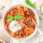 close up of bowl of lasagna soup topped with ricotta.