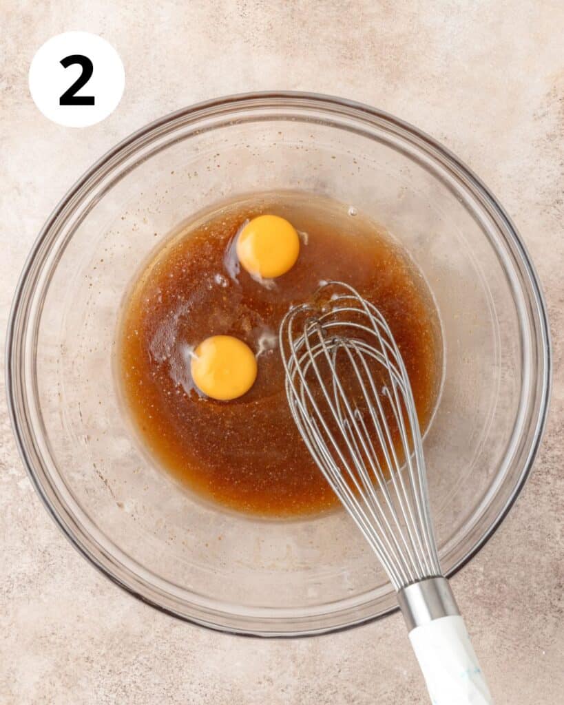 adding eggs to butter and sugars.