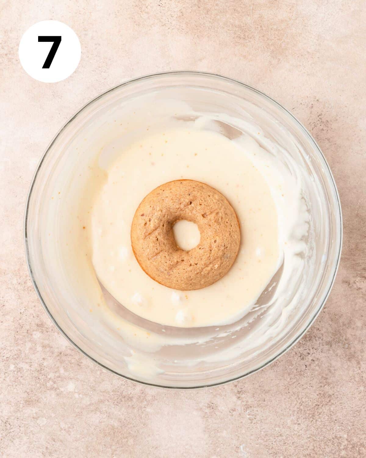 dipping pecan donuts in maple glaze.