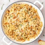 skillet of french onion chicken pasta with melted gruyere.